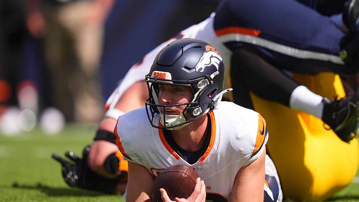 Sep 15, 2024; Denver, Colorado, USA; Denver Broncos quarterback Bo Nix (10) lays on the turf after a sack in the first quarter against the Pittsburgh Steelers at Empower Field at Mile High. Mandatory Credit: Ron Chenoy-Imagn Images