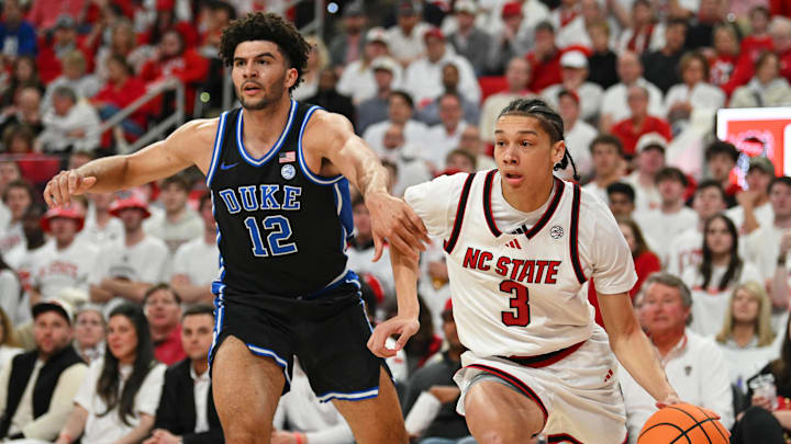 Mar 2, 2026; Raleigh, North Carolina, USA; NC State Wolfpack guard Matt Able (3) drives the ball around Duke Blue Devils forward Cameron Boozer (12) during the first half at Lenovo Center. Mandatory Credit: Zachary Taft-Imagn Images Mar 2, 2026; Raleigh, North Carolina, USA; NC State Wolfpack guard Matt Able (3) drives the ball around Duke Blue Devils forward Cameron Boozer (12) during the first half at Lenovo Center. Mandatory Credit: Zachary Taft-Imagn Images