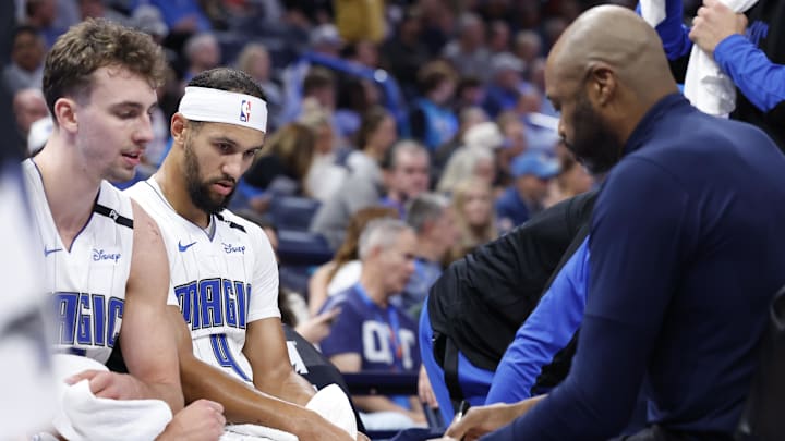 Nov 4, 2024; Oklahoma City, Oklahoma, USA; Orlando Magic guard Jalen Suggs (4) and forward Franz Wagner (22) listen to head coach Jamahl Mosley during a time out against the Oklahoma City Thunder in the second half at Paycom Center. Mandatory Credit: Alonzo Adams-Imagn Images Nov 4, 2024; Oklahoma City, Oklahoma, USA; Orlando Magic guard Jalen Suggs (4) and forward Franz Wagner (22) listen to head coach Jamahl Mosley during a time out against the Oklahoma City Thunder in the second half at Paycom Center. Mandatory Credit: Alonzo Adams-Imagn Images