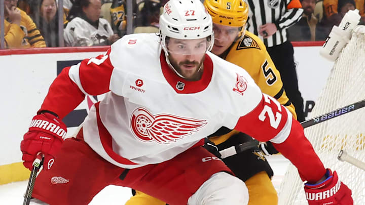 Jan 1, 2026; Pittsburgh, Pennsylvania, USA;  Detroit Red Wings center Michael Rasmussen (27) handles the puck as Pittsburgh Penguins defenseman Ryan Shea (5) and goaltender Arturs Silovs (37) defend during the third period at PPG Paints Arena. Mandatory Credit: Charles LeClaire-Imagn Images