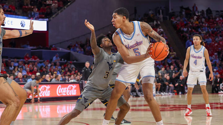 Jan 13, 2026; Houston, Texas, USA; West Virginia Mountaineers guard Honor Huff (3) defends Houston Cougars center Chris Cenac Jr. (5) in the second half  at Fertitta Center. Mandatory Credit: Thomas Shea-Imagn Images
