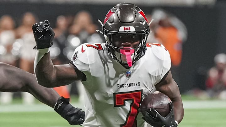 Oct 3, 2024; Atlanta, Georgia, USA; Tampa Bay Buccaneers running back Bucky Irving (7) runs with the ball against the Atlanta Falcons at Mercedes-Benz Stadium. Mandatory Credit: Dale Zanine-Imagn Images