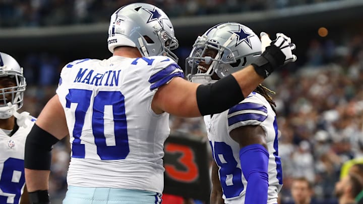Dallas Cowboys receiver CeeDee Lamb (88) celebrates his first-quarter touchdown with guard Zack Martin (70) against the Atlanta Falcons at AT&T Stadium.