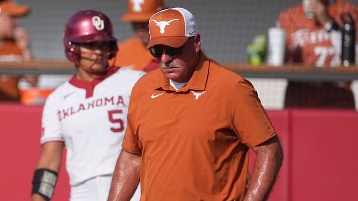 Texas Longhorns head coach Mike White walks to the pitcher's circle.