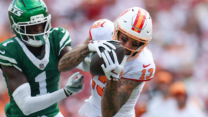 Sep 21, 2025; Tampa, Florida, USA; Tampa Bay Buccaneers wide receiver Mike Evans (13) catches a pass defended by New York Jets cornerback Sauce Gardner (1) at Raymond James Stadium.