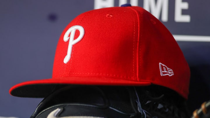 May 26, 2023; Atlanta, Georgia, USA; A detailed view of a Philadelphia Phillies hat and glove on the bench against the Atlanta Braves in the seventh inning at Truist Park. 
