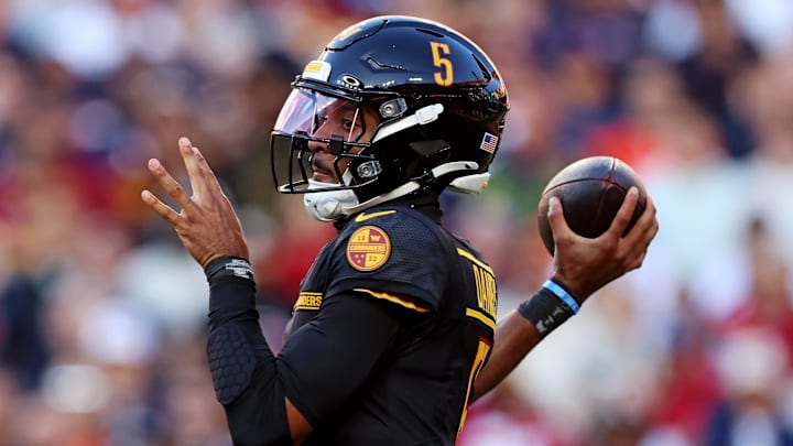 Oct 27, 2024; Landover, Maryland, USA; Washington Commanders quarterback Jayden Daniels (5) throws a pass during the first quarter against the Chicago Bears at Commanders Field. Mandatory Credit: Peter Casey-Imagn Images