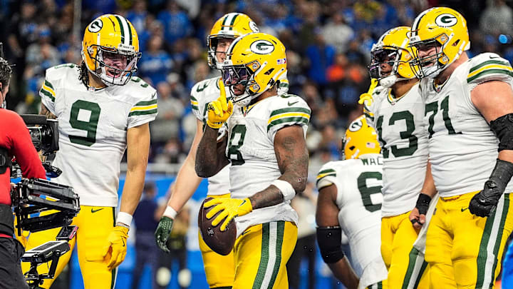 Green Bay Packers running back Josh Jacobs (8) celebrates a touchdown against Detroit Lions during the second half at Ford Field in Detroit on Thursday, Dec. 5, 2024.