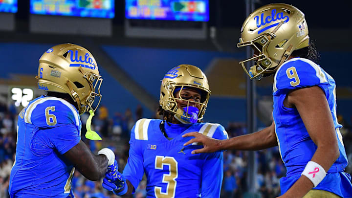Nov 8, 2025; Pasadena, California, USA; UCLA Bruins running back Anthony Woods (6) celebrates his touchdown scored against the Nebraska Cornhuskers with wide receiver Kwazi Gilmer (3) and quarterback Nico Iamaleava (9) during the second half at the Rose Bowl. Mandatory Credit: Gary A. Vasquez-Imagn Images