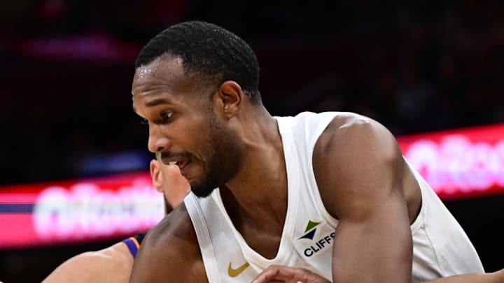 Cleveland Cavaliers center Evan Mobley dribbles away from Phoenix Suns guard Jordan Goodwin.