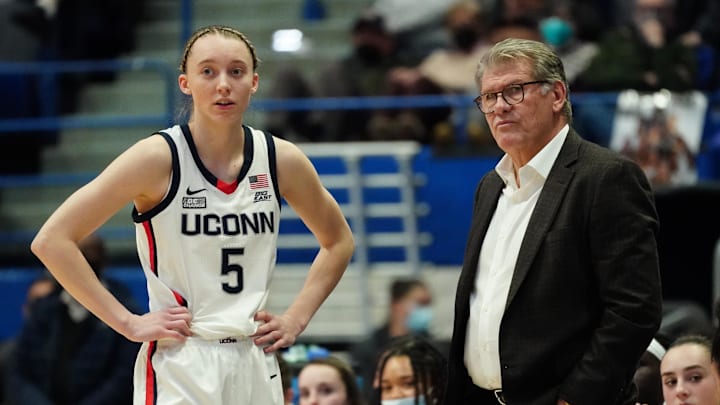 UConn Huskies star Paige Bueckers talks to coach Geno Auriemma on the sidelines.