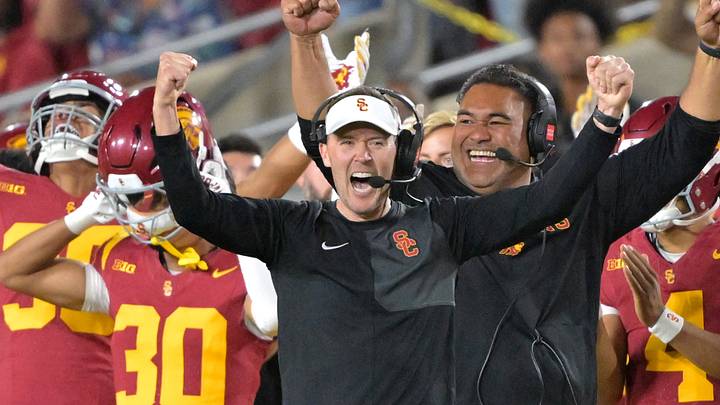 Oct 11, 2025; Los Angeles, California, USA; USC Trojans head coach Lincoln Riley (wearing white visor) celebrates along with defensive end coach Shaun Nua after kicker Ryon Sayeri (48) hit a 54-yard field goal in the second half against the Michigan Wolverines at United Airlines Field at the Los Angeles Memorial Coliseum. Mandatory Credit: Jayne Kamin-Oncea-Imagn Images Oct 11, 2025; Los Angeles, California, USA; USC Trojans head coach Lincoln Riley (wearing white visor) celebrates along with defensive end coach Shaun Nua after kicker Ryon Sayeri (48) hit a 54-yard field goal in the second half against the Michigan Wolverines at United Airlines Field at the Los Angeles Memorial Coliseum. Mandatory Credit: Jayne Kamin-Oncea-Imagn Images