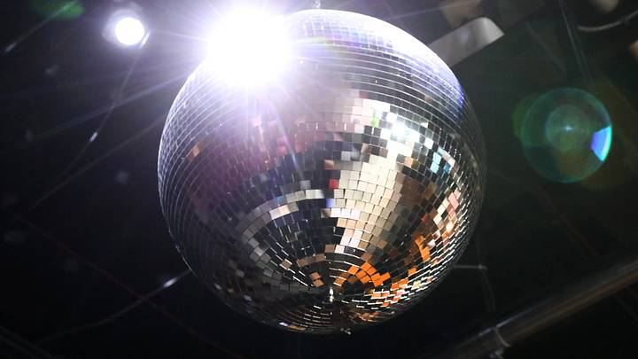 A disco ball shines over the dance floor at the newly opened Flora, on Monroe Ave in Rochester Tuesday, Dec. 16, 2025.