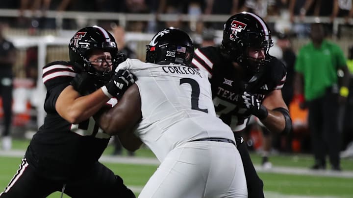 Texas Tech Red Raiders offensive lineman Davion Carter (56) blocks Cincinnati Bearcats defensive tackle Dontay Corleone (2) 