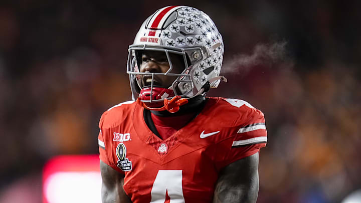 Dec 21, 2024; Columbus, Ohio, USA; Ohio State Buckeyes wide receiver Jeremiah Smith (4) celebrates after a touchdown catch against the Tennessee Volunteers during the second half of the College Football Playoff first round game at Ohio Stadium. Ohio State won 42-17. Mandatory Credit: Adam Cairns-Imagn Images