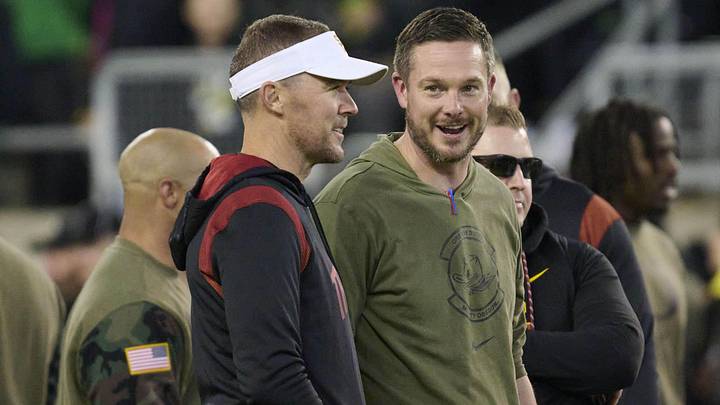 Nov 11, 2023; Eugene, Oregon, USA; USC Trojans head coach Lincoln Riley, left, and Oregon Ducks head coach Dan Lanning talk before a game at Autzen Stadium. Mandatory Credit: Troy Wayrynen-Imagn Images