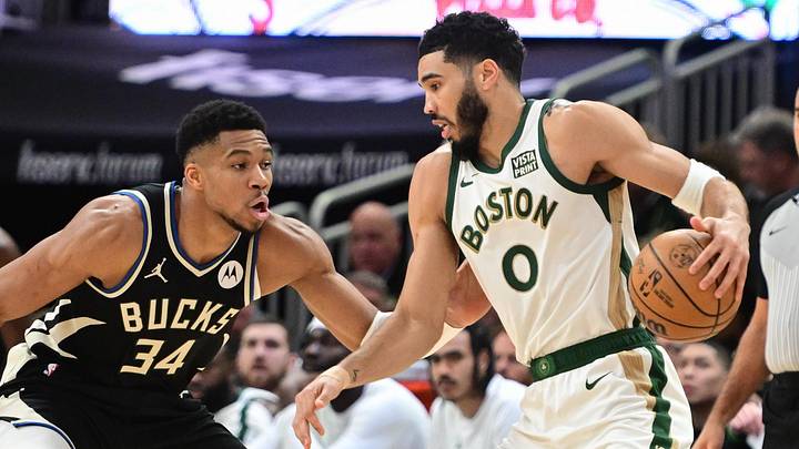 Jan 11, 2024; Milwaukee, Wisconsin, USA; Boston Celtics forward Jayson Tatum (0) drives for the basket against Milwaukee Bucks forward Giannis Antetokounmpo (34) in the second quarter at Fiserv Forum. Mandatory Credit: Benny Sieu-Imagn Images
