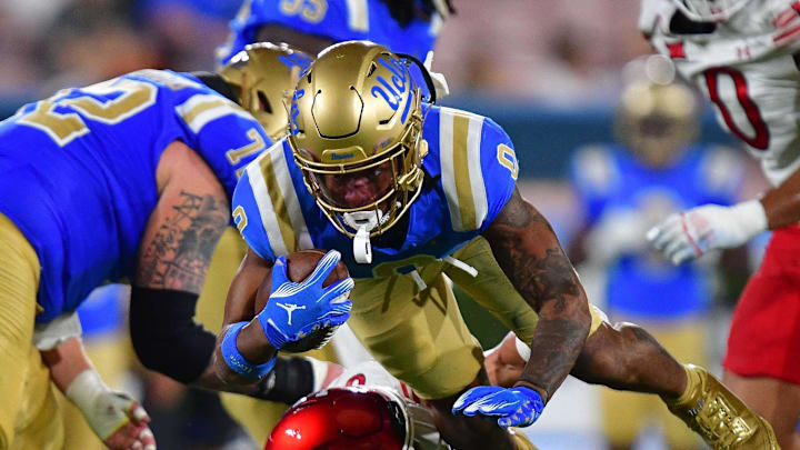 Aug 30, 2025; Pasadena, California, USA; UCLA Bruins quarterback Nico Iamaleava (9) moves the ball against Utah Utes linebacker Lander Barton (8) during the first half at Rose Bowl. Mandatory Credit: Gary A. Vasquez-Imagn Images