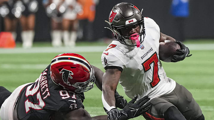 Oct 3, 2024; Atlanta, Georgia, USA; Tampa Bay Buccaneers running back Bucky Irving (7) is tackled by Atlanta Falcons defensive end Grady Jarrett (97) at Mercedes-Benz Stadium. Mandatory Credit: Dale Zanine-Imagn Images Oct 3, 2024; Atlanta, Georgia, USA; Tampa Bay Buccaneers running back Bucky Irving (7) is tackled by Atlanta Falcons defensive end Grady Jarrett (97) at Mercedes-Benz Stadium. Mandatory Credit: Dale Zanine-Imagn Images
