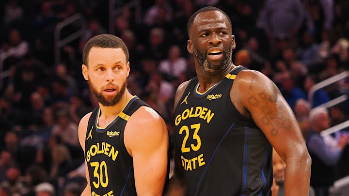 Feb 3, 2025; San Francisco, California, USA; Golden State Warriors guard Stephen Curry (30) and forward Draymond Green (23) look towards an Orlando Magic player at half time at Chase Center. Mandatory Credit: Kelley L Cox-Imagn Images