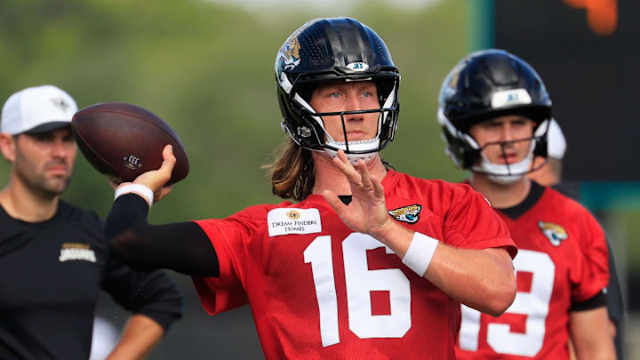 Jacksonville Jaguars quarterbacks Trevor Lawrence (16) throws the ball as Seth Henigan (19), John Wolford (18) look on during an NFL training camp session at the Miller Electric Center, Friday, July 25, 2025, in Jacksonville, Fla. [Corey Perrine/Florida Times-Union]