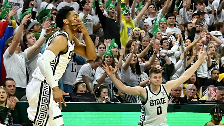 Jan 30, 2024; East Lansing, Michigan, USA; Michigan State Spartans forward Jaxon Kohler (0) celebrates a three point shot by Michigan State Spartans guard Jaden Akins (3) in the foreground during the second half against the Michigan Wolverines at Jack Breslin Student Events Center. Mandatory Credit: Dale Young-Imagn Images Jan 30, 2024; East Lansing, Michigan, USA; Michigan State Spartans forward Jaxon Kohler (0) celebrates a three point shot by Michigan State Spartans guard Jaden Akins (3) in the foreground during the second half against the Michigan Wolverines at Jack Breslin Student Events Center. Mandatory Credit: Dale Young-Imagn Images