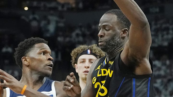 May 6, 2025; Minneapolis, Minnesota, USA; Minnesota Timberwolves guard Anthony Edwards (5) controls the ball against Golden State Warriors forward Draymond Green (23) in the first quarter during game one of the second round for the 2025 NBA Playoffs at Target Center. Mandatory Credit: Bruce Kluckhohn-Imagn Images