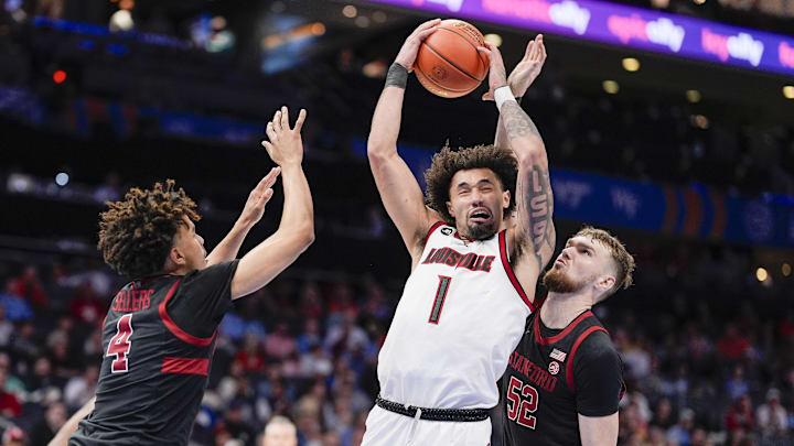 Mar 13, 2025; Charlotte, NC, USA; Louisville Cardinals guard J'Vonne Hadley (1) is blocked by Stanford Cardinal forward Aidan Cammann (52) during the second half at Spectrum Center. Mandatory Credit: Jim Dedmon-Imagn Images