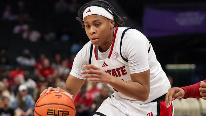 Nov 9, 2025; Charlotte, North Carolina, USA;  NC State Wolfpack guard Zoe Brooks (35) drives the ball against the Southern California Trojans during the second quarter of the Ally Tipoff game at Spectrum Center. Mandatory Credit: Cory Knowlton-Imagn Images