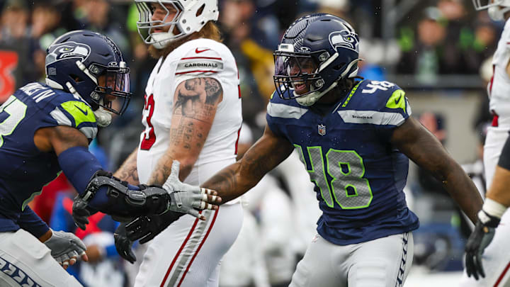 Nov 24, 2024; Seattle, Washington, USA; Seattle Seahawks linebacker Tyrice Knight (48) celebrates with linebacker Ernest Jones IV (13) following a sack against the Arizona Cardinals during the first quarter at Lumen Field.