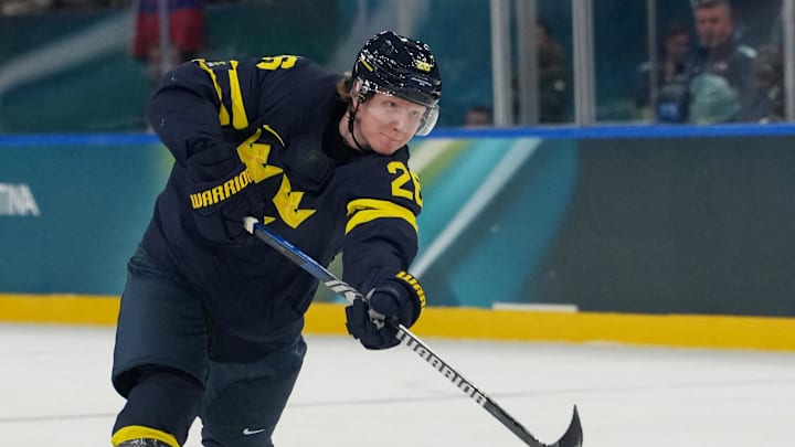 Feb 14, 2026; Milan, Italy; Rasmus Dahlin of Sweden shoots at goal during a Group B men's ice hockey game during the Milano Cortina 2026 Olympic Winter Games at Milano Santagiulia Ice Hockey Arena. Mandatory Credit: James Lang-Imagn Images