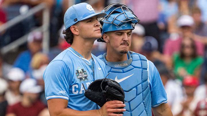 Jun 20, 2026; Omaha, NE, USA; North Carolina Tar Heels starting pitcher Jason DeCaro (29) and catcher Colin Hynek (23) walk off during the first inning against the Oklahoma Sooners at Charles Schwab Field. Mandatory Credit: Dylan Widger-Imagn Images