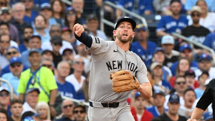 Oct 4, 2025; Toronto, Ontario, CAN; New York Yankees third baseman Ryan McMahon (19) throws to first for an out in the first inning against the Toronto Blue Jays during game one of the ALDS round for the 2025 MLB playoffs at Rogers Centre. Mandatory Credit: Dan Hamilton-Imagn Images