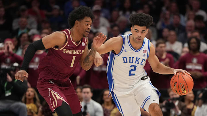 Duke guard Cayden Boozer drives with the ball against Florida State guard Martin Somerville during the ACC tournament.