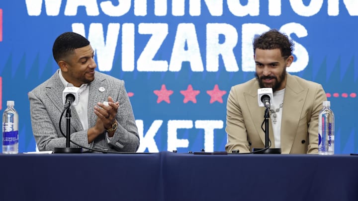 Jan 9, 2026; Washington, District of Columbia, USA; Washington Wizards general manager Will Dawkins (L) introduces newly acquired Wizards guard Trae Young (R) at a press conference prior to the Wizards' game against the New Orleans Pelicans at Capital One Arena. Mandatory Credit: Geoff Burke-Imagn Images