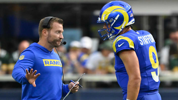Oct 6, 2024; Inglewood, California, USA; Los Angeles Rams head coach Sean McVay talks to quarterback Matthew Stafford (9) during the third quarter against the Green Bay Packers at SoFi Stadium. Mandatory Credit: Robert Hanashiro-Imagn Images