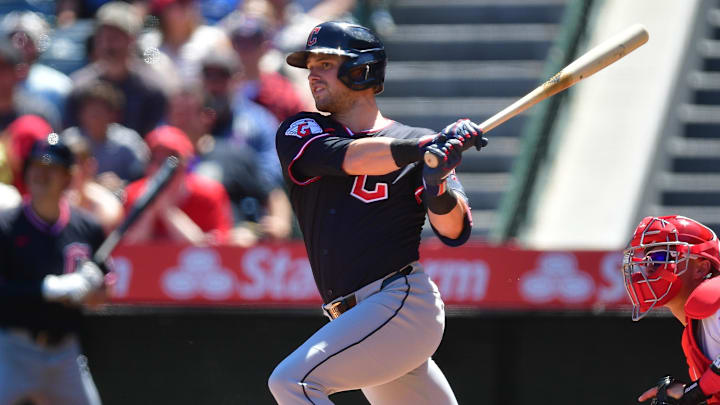 Apr 6, 2025; Anaheim, California, USA; Cleveland Guardians center fielder Lane Thomas (8) hits a sacrifice RBI against the Los Angeles Angels during the first inning at Angel Stadium. Mandatory Credit: Gary A. Vasquez-Imagn Images