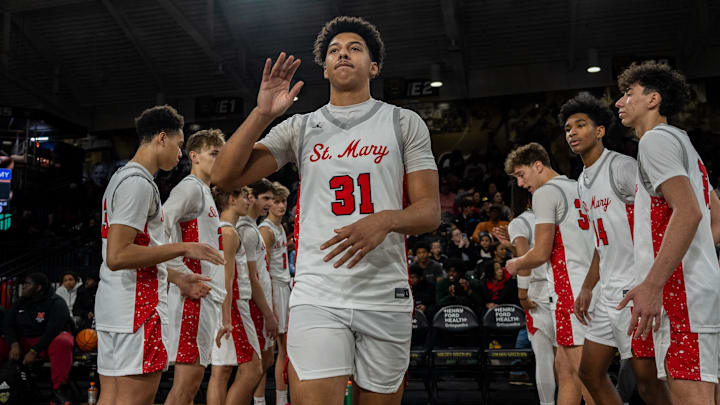 Orchard Lake St. Mary’s Jayden Savoury (31) high-fives his teammate before their game against IMG Academy at Oakland University in Rochester on Thursday, Jan. 9, 2025. Orchard Lake St. Mary’s Jayden Savoury (31) high-fives his teammate before their game against IMG Academy at Oakland University in Rochester on Thursday, Jan. 9, 2025.