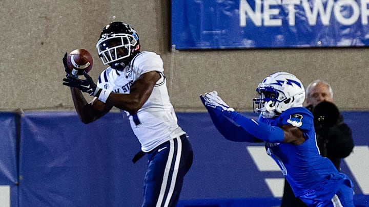 Sep 15, 2023; Colorado Springs, Colorado, USA; Utah State Aggies wide receiver Jalen Royals (1) makes a catch for a touchdown against Air Force Falcons defensive back Trey Williams (0) in the third quarter at Falcon Stadium. Mandatory Credit: Isaiah J. Downing-Imagn Images Sep 15, 2023; Colorado Springs, Colorado, USA; Utah State Aggies wide receiver Jalen Royals (1) makes a catch for a touchdown against Air Force Falcons defensive back Trey Williams (0) in the third quarter at Falcon Stadium. Mandatory Credit: Isaiah J. Downing-Imagn Images