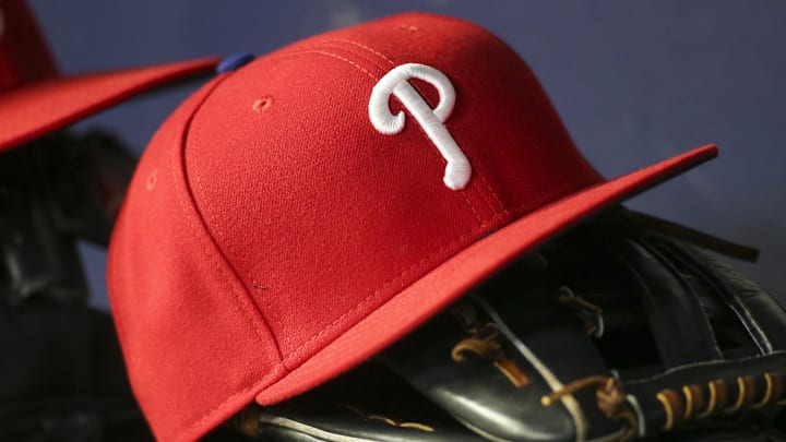 May 25, 2022; Atlanta, Georgia, USA; Detailed view of a Philadelphia Phillies hat and glove in the dugout against the Atlanta Braves in the eighth inning at Truist Park. 