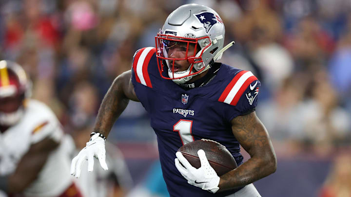 Aug 8, 2025; Foxborough, Massachusetts, USA; New England Patriots receiver Ja'Lynn Polk (1) runs the ball during the first half against the Washington Commanders at Gillette Stadium. Mandatory Credit: Paul Rutherford-Imagn Images