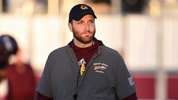 Walsh Jesuit football coach Nick Alexander looks on during warmups as the Warriors played St. Vincent-St. Mary on Friday, Oct. 21, 2022.