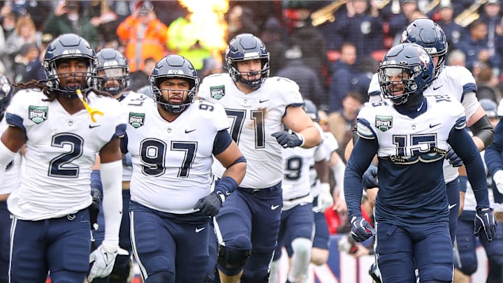 UConn Football Adds Elite Duke Defender Desmond AladugeRante Jones, left, and Tui Faumuina-Brown lead the team out of the tunnel during the third annual Wasabi Fenway Bowl against North Carolina at Fenway Park on Saturday, Dec. 28, 2024.