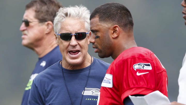 Jul 30, 2016; Renton, WA, USA; Seattle Seahawks head coach Pete Carroll talks with quarterback Russell Wilson (3) during training camp at Virginia Mason Athletic Center. Mandatory Credit: Joe Nicholson-Imagn Images