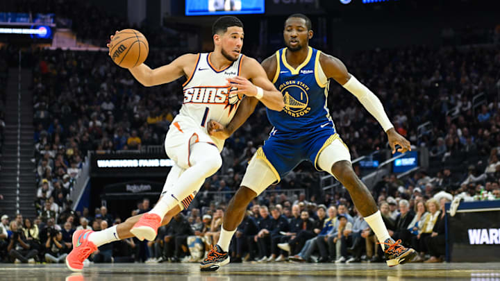 Nov 4, 2025; San Francisco, California, USA; Phoenix Suns guard Devin Booker (1) drives to the basket against Golden State Warriors forward Jonathan Kuminga (1) in the second quarter at Chase Center. Mandatory Credit: Eakin Howard-Imagn Images