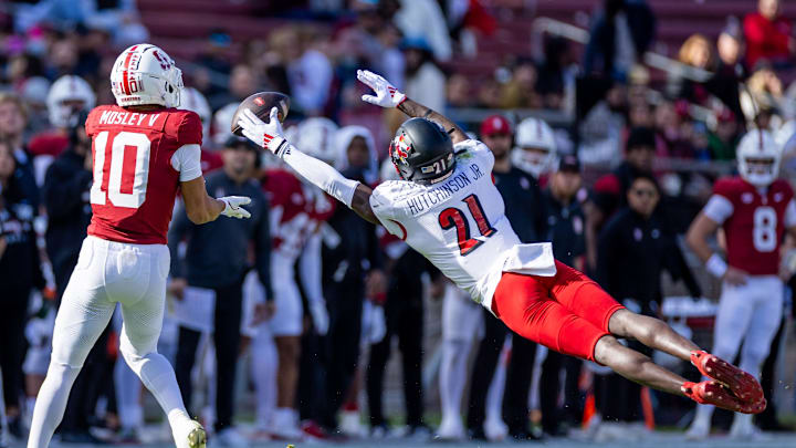 Nov 16, 2024; Stanford, California, USA;  Louisville Cardinals defensive back D'Angelo Hutchinson (21) attempts to deflect a pass to Stanford Cardinal wide receiver Emmett Mosley V (10) during the first quarter at Stanford Stadium. Mandatory Credit: Bob Kupbens-Imagn Images