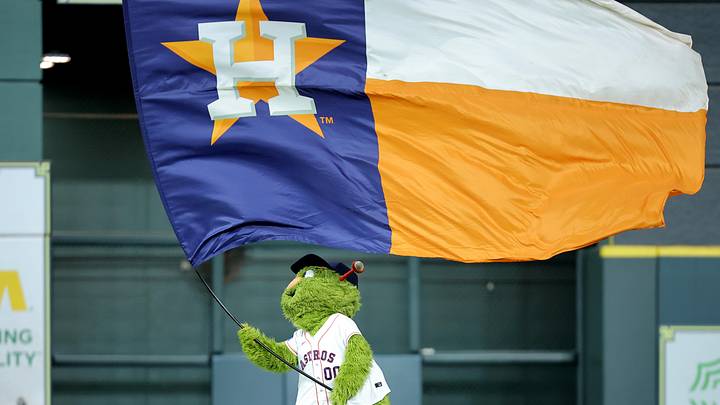 Houston Astros mascot Orbit waves a flag in center field after the final out. Houston Astros mascot Orbit waves a flag in center field after the final out.