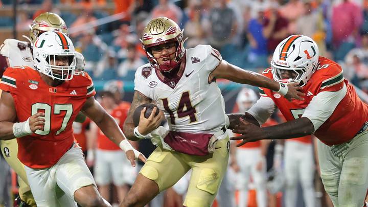 Oct 17, 2026; Miami Gardens, Florida, USA; Florida State Seminoles quarterback Ashton Daniels (14) runs against Miami Hurricanes defensive line Justin Scott (5) and defensive line Keona Davis (97) during the second quarter at Hard Rock Stadium. Mandatory Credit: Sam Navarro-Imagn Images Oct 17, 2026; Miami Gardens, Florida, USA; Florida State Seminoles quarterback Ashton Daniels (14) runs against Miami Hurricanes defensive line Justin Scott (5) and defensive line Keona Davis (97) during the second quarter at Hard Rock Stadium. Mandatory Credit: Sam Navarro-Imagn Images