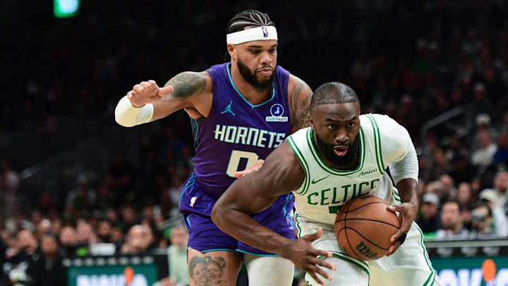 Mar 4, 2026; Boston, Massachusetts, USA;  Boston Celtics guard Jaylen Brown (7) controls the ball while Charlotte Hornets forward Miles Bridges (0) defends during the first half at TD Garden. Mandatory Credit: Bob DeChiara-Imagn Images