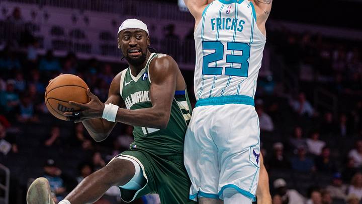 Oct 11, 2026; Charlotte, North Carolina, USA;  Milwaukee Bucks guard Caris LeVert (12) looks to pass around Charlotte Hornets forward Wyatt Fricks (23) in the fourth quarter at Spectrum Center.  Mandatory Credit: Scott Kinser-Imagn Images